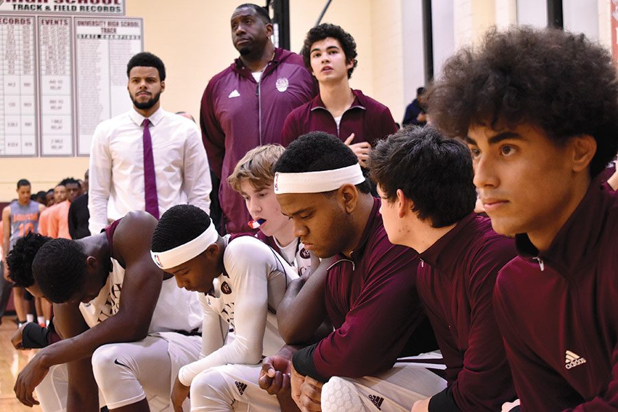 #TAKEAKNEE. Members of the boys varsity basketball team kneel during the national anthem before a home game Dec. 1.  Juniors Mohammed Alausa and Johnny Brown led the effort on the team to kneel as a form of protest against police brutality.