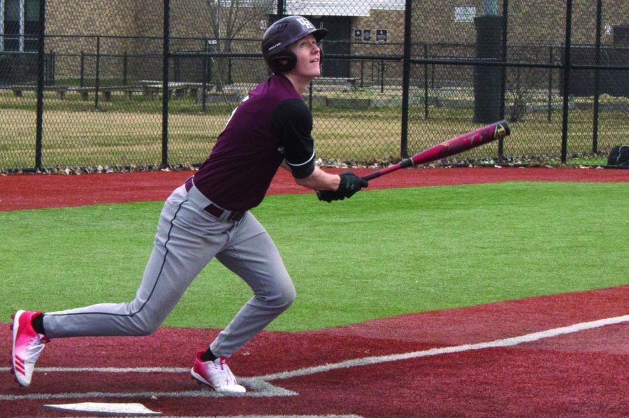 ROOKIE AT BAT. Junior Nick Beach keeps his eyes on the ball as he hits it into the outfield at the varsity baseball game against Corliss High School April 6. Nick joined the team this year after his hockey season came to an end.