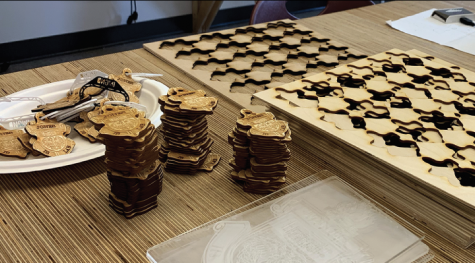 MAKING WAVES IN THE MAKERSPACE. Stacks of carved wooden keychain acessories reading “Jones Is Lab” await distribution. Students have used the makerspace to laser-cut the medallions, which have been in increasing demand.