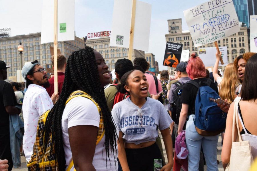 POWER IN NUMBERS. Chanting along with students from Kenwood Academy, juniors Kennedy Coats and Destiney Williamson chant turn on to Michigan Avenue, as they near the end of the Global Climate Strike. 