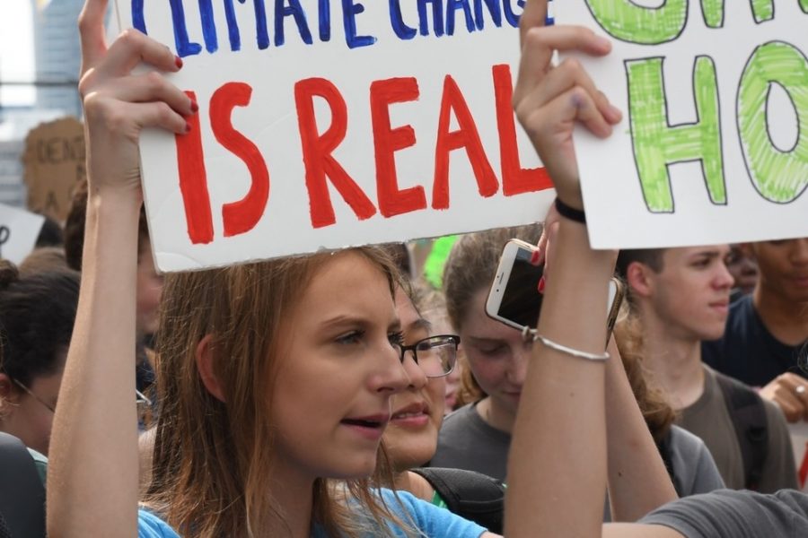 CHANTING FOR CHANGE. U-High senior Joana Rose and other students walk out to protest in the Global Climate Strike on Sept. 20.