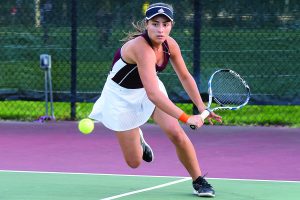TIGHT-KNIT TENNIS TEAM. Senior Isabella Kellermeier sprints to the ball during a tennis match against Elgin Academy Sept. 17. U-High won the match 5-0. The girls tennis team is undefeated and players pride themselves in their welcoming team environment.