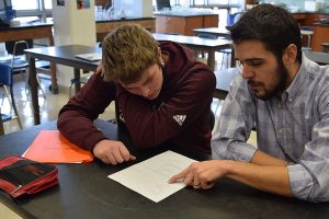 REVIEWING WORK. Science teacher Zachary Hund, at right, reviews a quiz with Zach Leslie, his Organic Chemistry student. Although it looks different in every classroom, Dr. Hund is among the teachers who have implemented the gradeless system in the classroom to reduce stress.