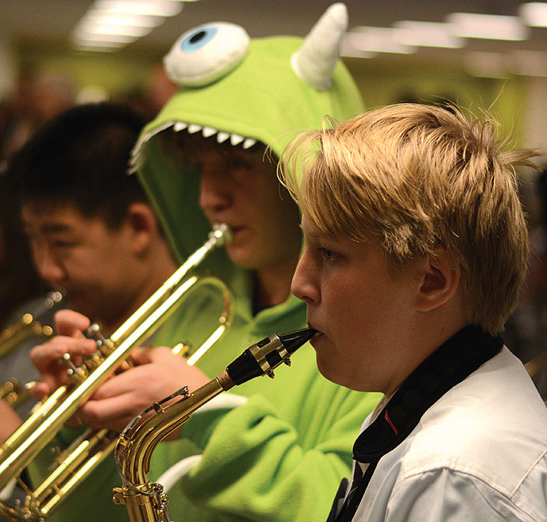 HAUNTING HORNS. Band members perform in Café Lab for parading students during the lower school’s Halloween costume parade. The band also performed at Earl Shapiro Hall, where the celebration was inside due to cold and snow.