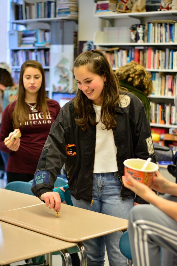 Sophomore Natalie Hultquist spins a dreidel at the Jewish Students Association's Hanukkah celebration Dec. 13.