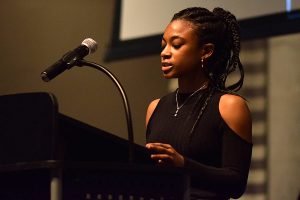Junior Mikaela Ewing, a member of the Black Students’ Association leadership board, reads aloud part of an open letter to the U-High community at the end of the Martin Luther King assembly Jan. 16.