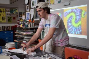 Marc Mulligan demonstrates tie-die in the 2019 ArtsFest workshop Tambourines, Tangerines, and Tie-dye. ArtsFest is a day filled with art-themed workshops designed by students, for students.