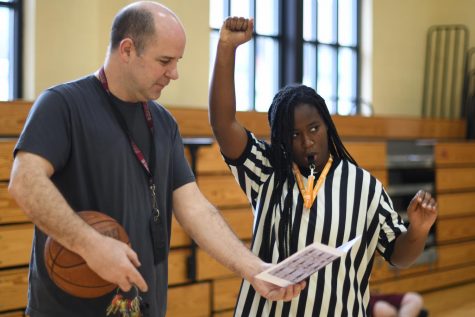 BLOW THE WHISTLE. P.E. teacher Daniel Dyra coaches junior Kennedy Coats on specific refereeing signals. Mr. Dyra, who has been a basketball referee for 30 seasons, taught all of his basketball classes the basics on refereeing signals and commands.