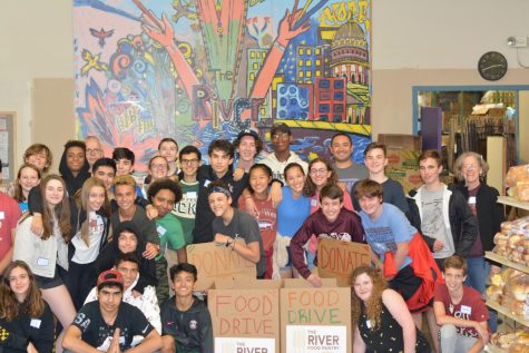 Having taken their first step on their service journey, a group of sophomores poses at their sophomore retreat service site, The River Food Pantry, Sept. 19. Many members of the class of 2022 have had difficulty completing that journey because of COVID-19, leading to the requirement being reduced to 20 hours from 40.