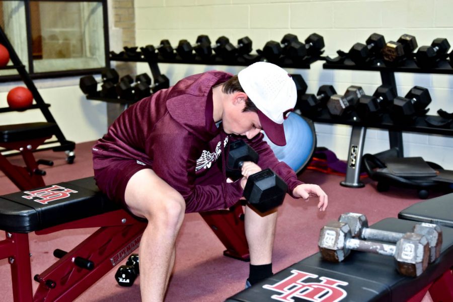 Senior Julian Skosey-LaLonde trains with a dumbbell in the fitness center in October 2019.