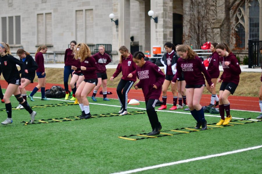 The girls soccer team does warm up drills before practice on March 11, only a few days before the announcement that Lab was to go online. In an effort to stay in touch while also abiding by social distancing measures, the team has bonded in creative ways such as a rock-paper-scissors tournament and other games.