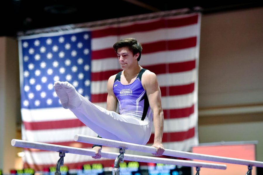 SOAR. Gymnast Sebastian Ingersoll, U-High senior, competes on the parallel bars at a national competition.