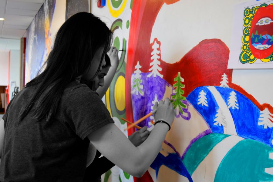 Students paint a mural at last years Artsfest in the hallway between the high school building and Gordon Parks Arts Hall.