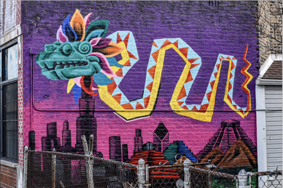 A dragon is painted in vibrant colors on a building in Gage Park, representing just one of many murals in the area.