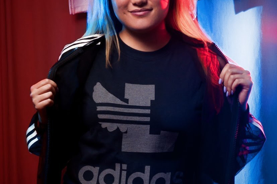 Lab alumna Ellen Ma shows off clothing from a Leaders 1354 collaboration with Adidas. 