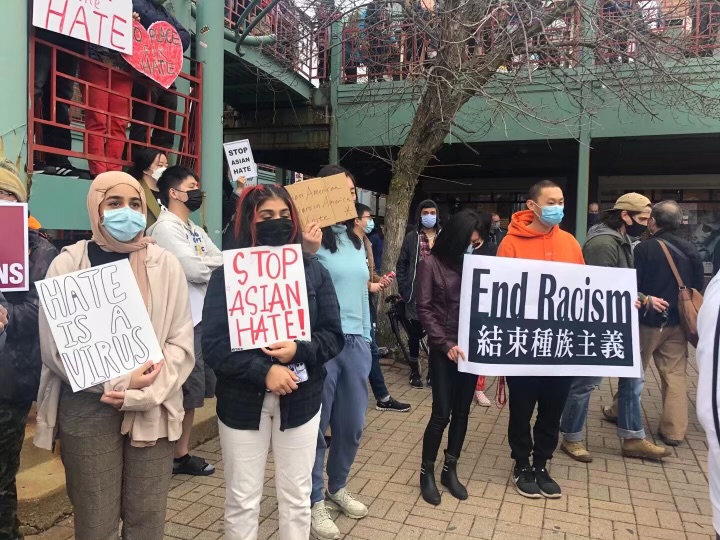 Protestors hold up messages against anti-Asian violence in Chinatown Square on March 27. The protest was in response to the shooting in Atlanta, Georgia killing eight people, including six women of Asian descent. 