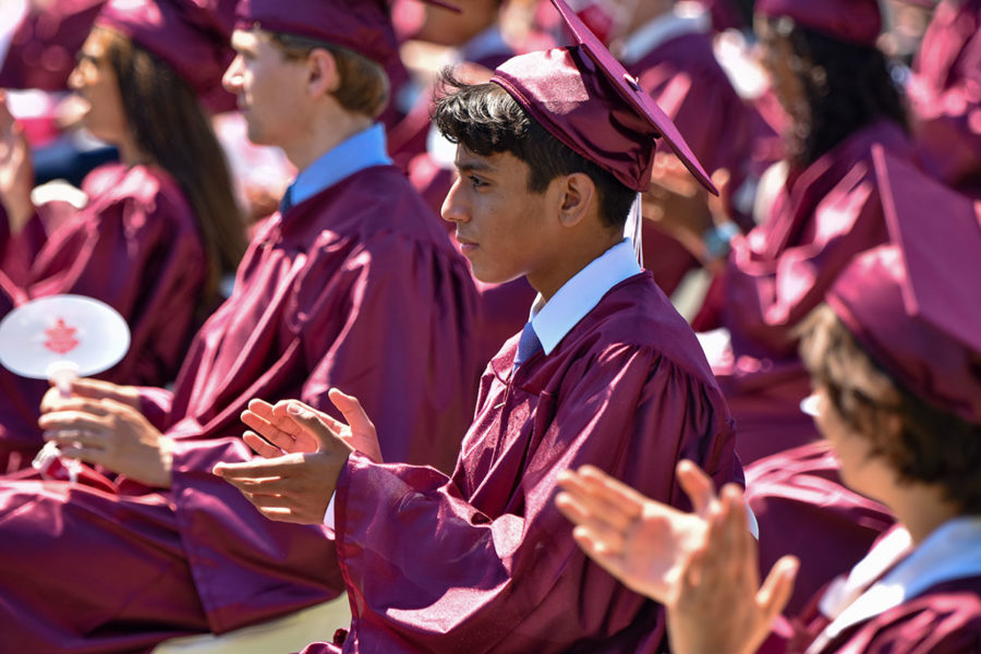 MAROON PRIDE. Seniors applaud the speeches of faculty and their peers. Speakers reflected on the past four years and shared advice for the future. Photo by Elliott Taylor