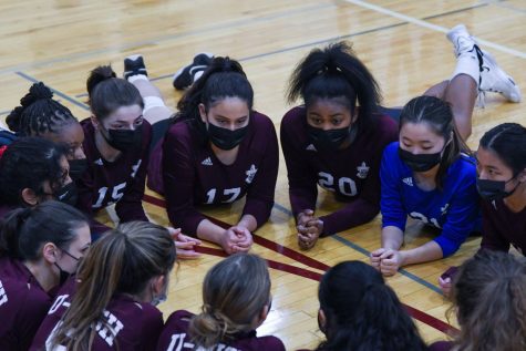 The volleyball team huddles together before a game on senior night on Oct. 21. The Maroons finished their season winning the ISL conference and the regional championship. 