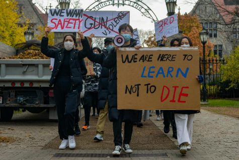 Individuals rally during a student-run protest Nov. 16 on the lack of campus security on the University of Chicago Main Quadrangle after the off-campus shooting death of Shaoxiong Zheng. Students chanted One block off campus and We are here to learn, not to die.
