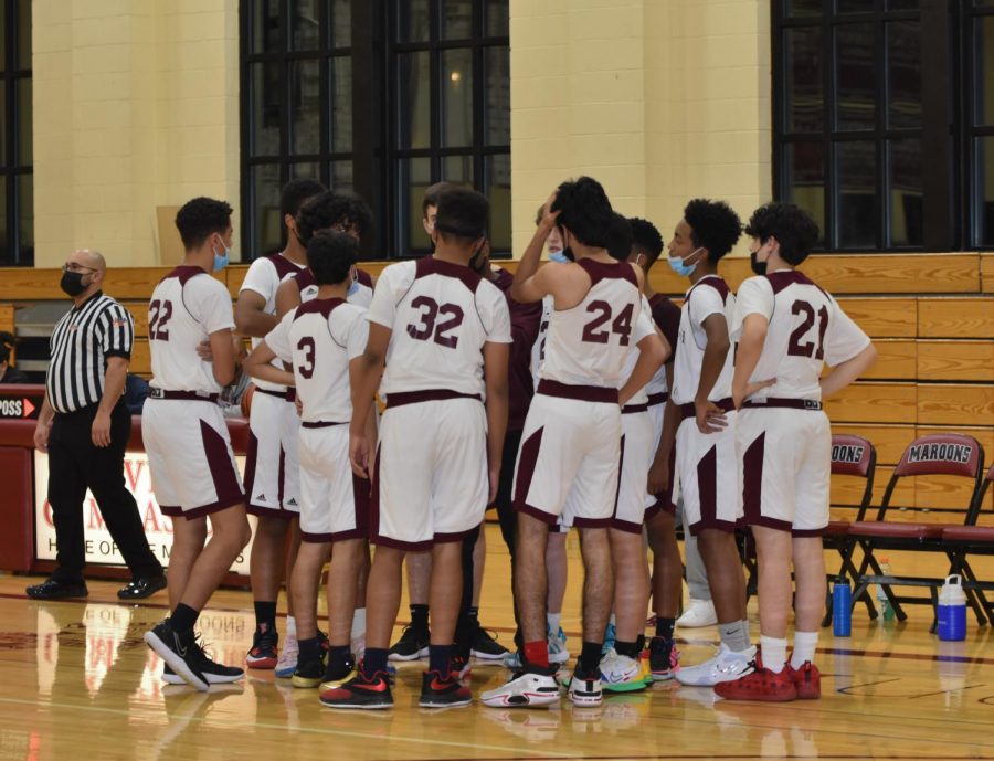 The Fresh/Soph Boys Basketball team huddles up during their game against Northridge College Prep. The team lost the game and is currently 0-1.