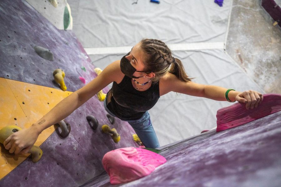 GETTING+A+GRIP.+Senior+Sophie+Volchenboum+looks+for+her+next+move+while+she+scales+a+bouldering+problem+at+First+Ascent+in+Humboldt+Park+on+Dec.+8.++%E2%80%9CCompetitions+are+about+how+high+you+can+get+on+a+route%2C+and+when+you%E2%80%99re+climbing+in+a+gym+your+goal+is+to+finish+the+route+however+you+can%2C%E2%80%9D+Sophie+said.+%E2%80%9CYou+don%E2%80%99t+get+any+style+points+here%2C+you%E2%80%99re+not+timed.+You+just+want+to+get+to+the+top.%E2%80%9D