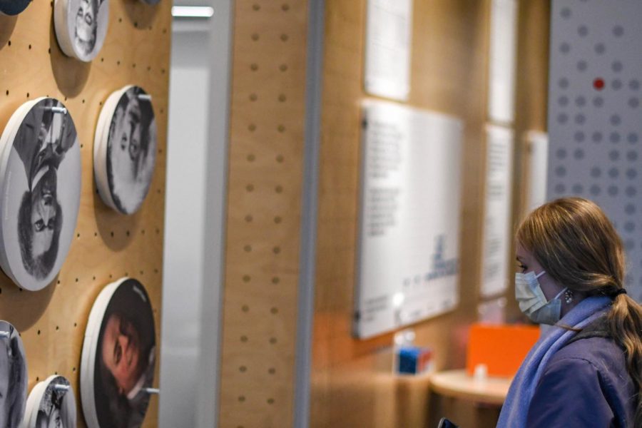 A woman observes portraits of famous thinkers at the Mindworks exhibit by University of Chicago’s Center for Decision Research. Guests contribute to research by interacting with the exhibit. 