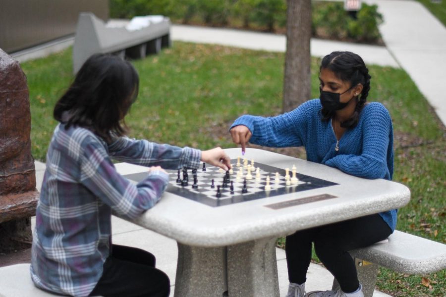 Juniors Asha Patel and Kiran Chinniah play a game of chess at the new tables in the courtyard between Gordon Parks Arts Hall and the high school building. The chess tables were donated by a group of Laboratory Schools alumni in honor of Chris Janus, former high school history teacher.