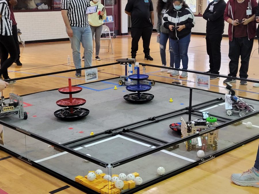 Drivers from the Sprockets & Screws robotics team try to put freight into a goal faster than their opponents during the First Tech Challenge competition Dec. 11.