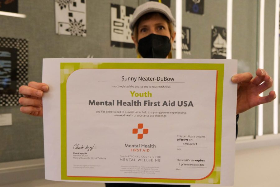Fine arts department chair Sunny Neater poses with her Mental Health First Aid certificate. The training took Ms. Neater 30 hours to complete.