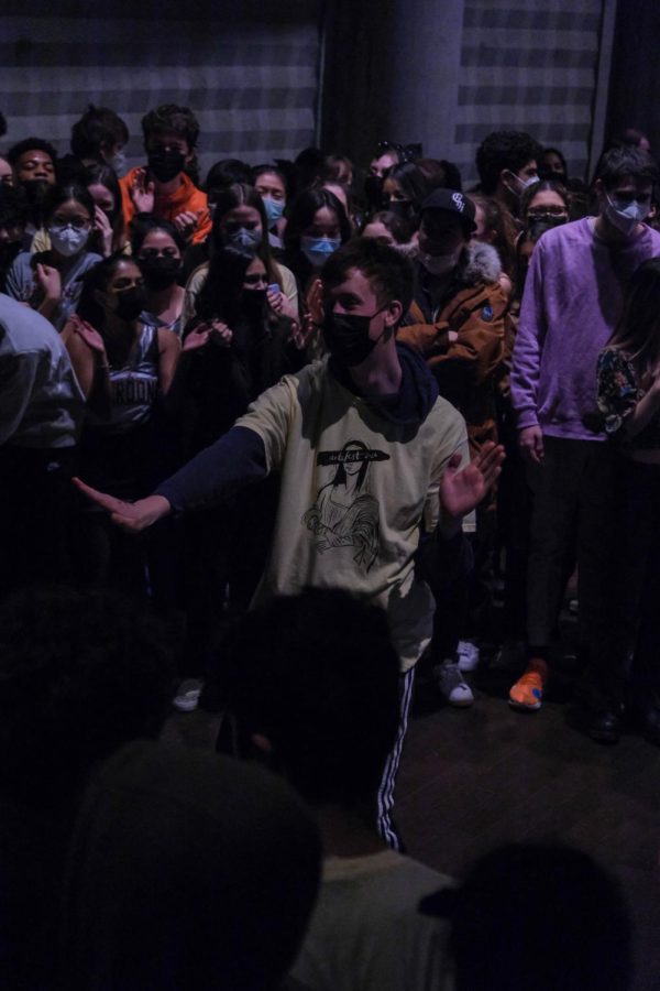 Junior William Meyer dances in the mosh pit during the ArtsFest closing assembly in Gordon Parks Arts Hall.