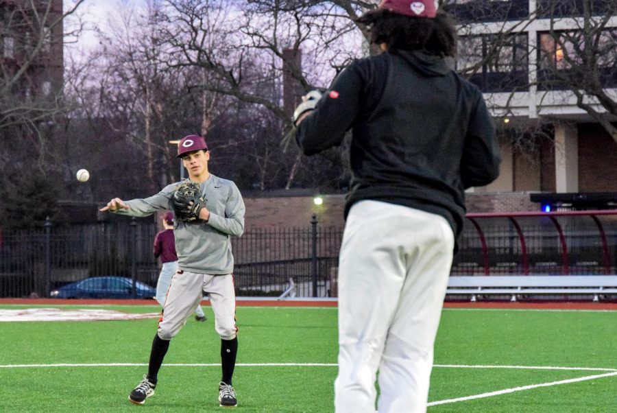 During baseball practice March 1, freshman Ryan Roggin throws the ball to his teammate freshman Marcus Wolfe during a drill. 