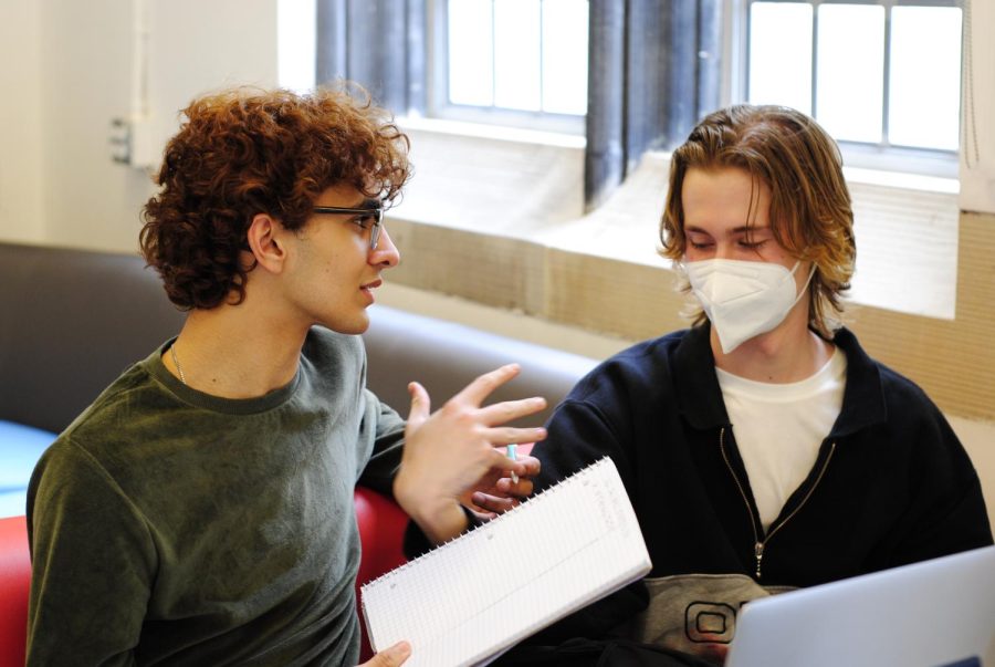 On March 21, the first day of optional mask wearing, sophomores Adam Cheema and Reid Surmeier talk in the second floor lounge.