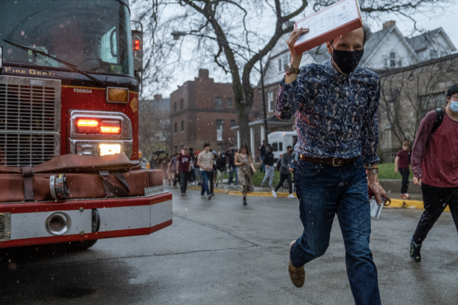After the fire department gave the all clear, physics teacher Javier Saez de Adana flees the rain that started to fall.