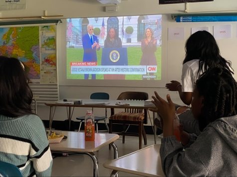 Young Women of Color club members Taylor Patterson, Raven Reid and Kiran Chinniah applaud while watching Ketanji Brown Jackson’s Supreme Court acceptance speech.