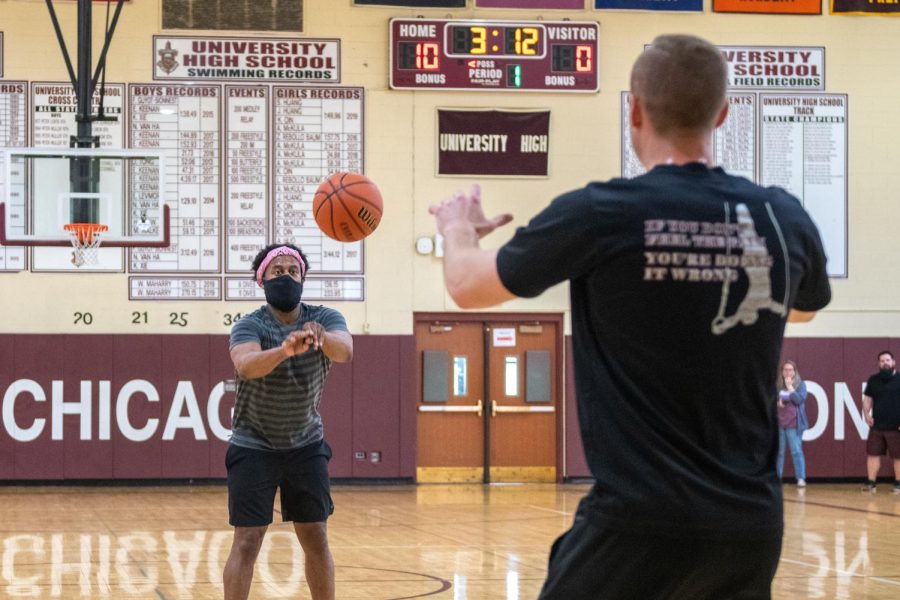 Counselor Teddy Stripling tosses the basketball to P.E. teacher Josh Potter