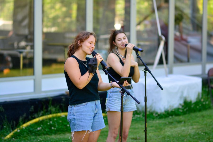 Ava+Eggner+and+Sophie+Volchenbaum+sing+a+duet+at+last+years+Labstock.+The+end-of-year+event+allows+students+to+perform+live+music+in+front+of+their+peers.