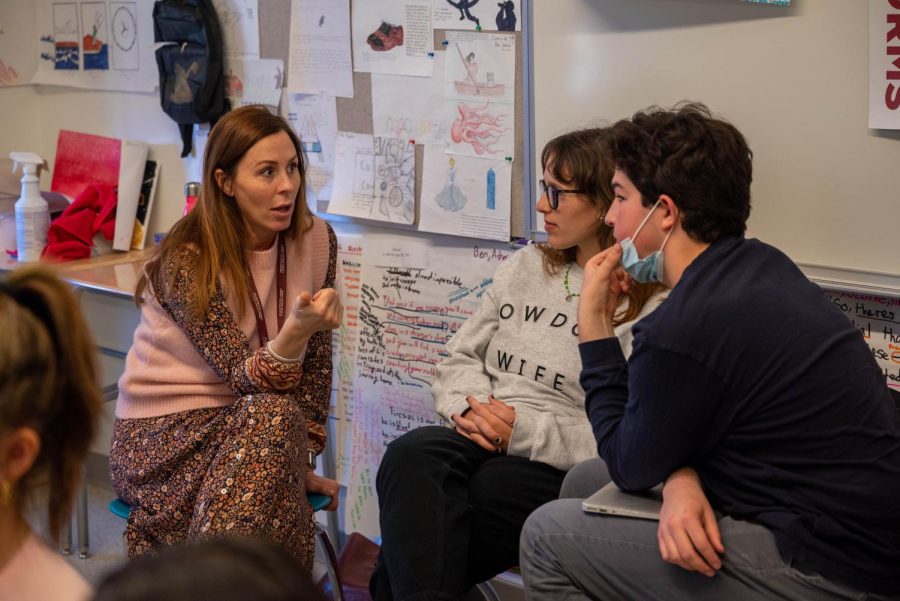 English teacher Christine Himmelfarb converses at a workshop with seniors Ava Eggner and Ben Sachs. 