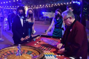 Students gather around a roulette table at last years Prom, hosted on Kenwood Mall. This years prom will be hosted at the Zhou B. Arts Center in Bridgeport, the first off-campus prom since 2019. 