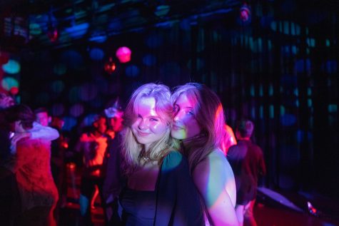 Seniors Charlotte Henderson and Gretchen Matzke pose in the Sherry Lansing theater during the homecoming dance on Sept. 24.