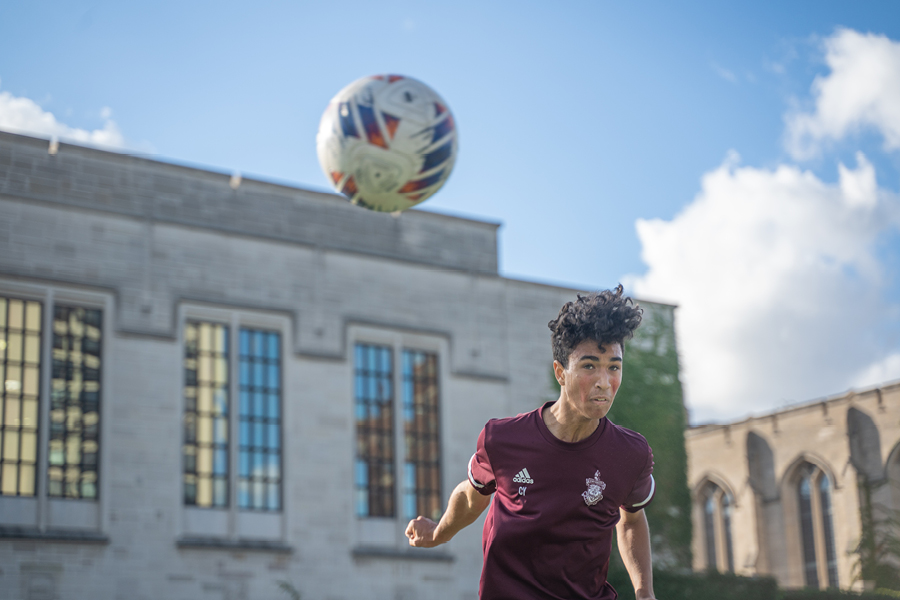 Varsity soccer captain Charlie Young goes for a header during practice after school on Sept. 22. Charlie has played for U-High since ninth grade, gaining confidence in his skills and in leadership.