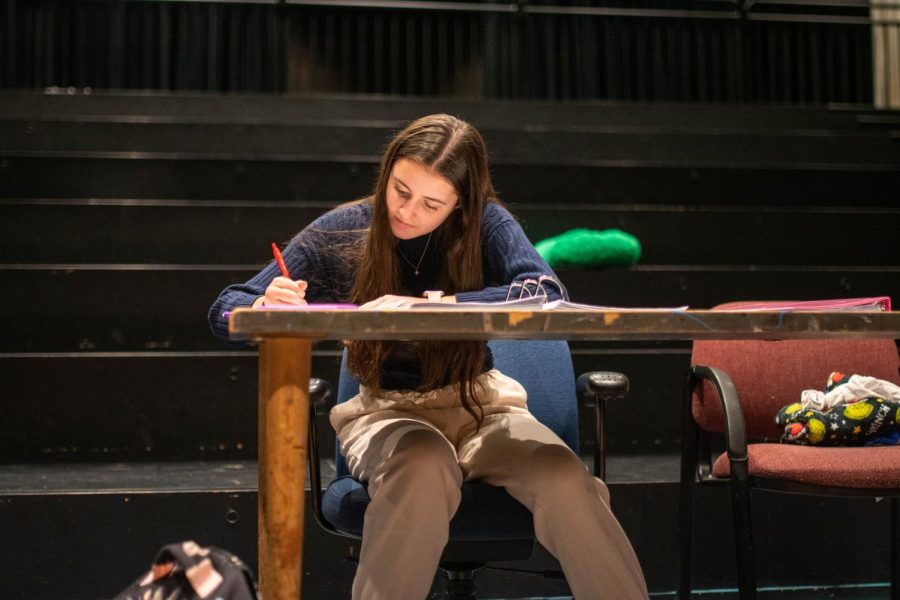 Senior Anna Bohlen works at the set of the upcoming fall play “the Firebugs.” She serves as theater manager and plays the role of “Anna” in the production. 