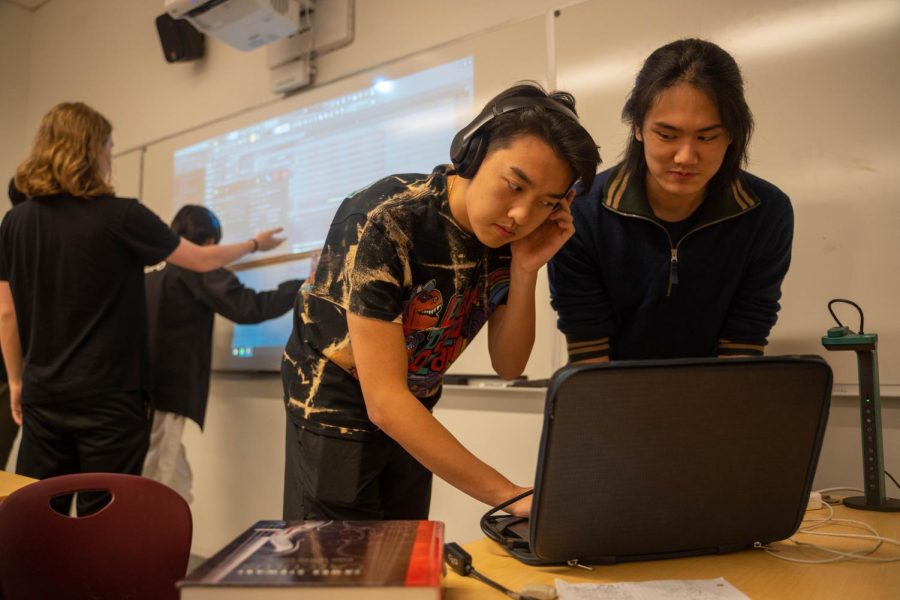 Beatmaking club co-founder Evan Lok listens to his music production while co-founder Jacob Liu watches on. The new club helps students learn about digital music making. 