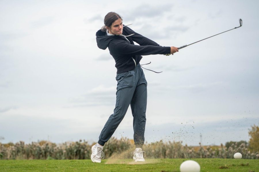 Maxine Hurst takes a swing during practice. Maxine and her teammate Amelia Tan competed in the IHSA A1 Championship and placed 35th and 19th.