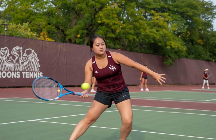 Senior Corona Chen takes a swing during a match against Regina Dominican High School on September 15. Corona and two of her teammates qualified for the IHSA state championship.