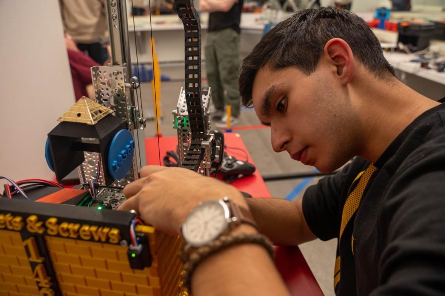 Senior Nico Ahmed, a member of Sprockets & Screws, works on his teams robot in preparation for the regional competition. 
