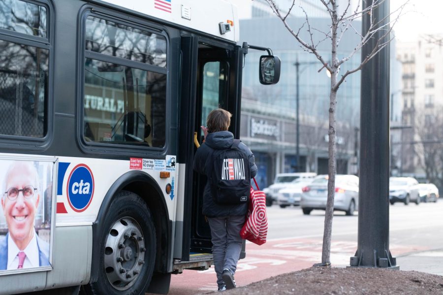 A Chicago resident boards a CTA bus, many city residents who take public transportation are struggling with heating their homes this winter. 