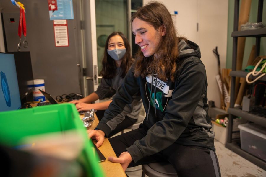 Robotics team members Ava Cohen and Asher Grossman work together in the robotics room. The team brings people together and creates a family around their shared passion.