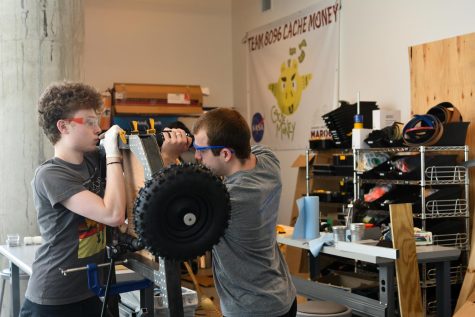 Seniors Peter Cox and Jay Molony work together to build a go-kart for their groups May Project.