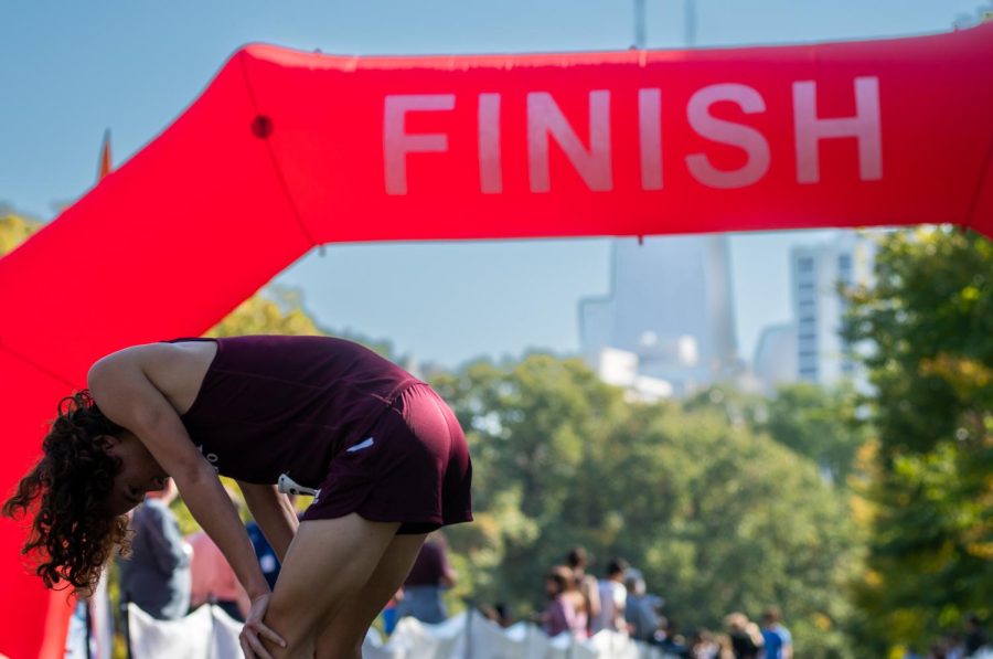After crossing the finish line, sophomore Oliver Go catches his breath on Oct. 21.