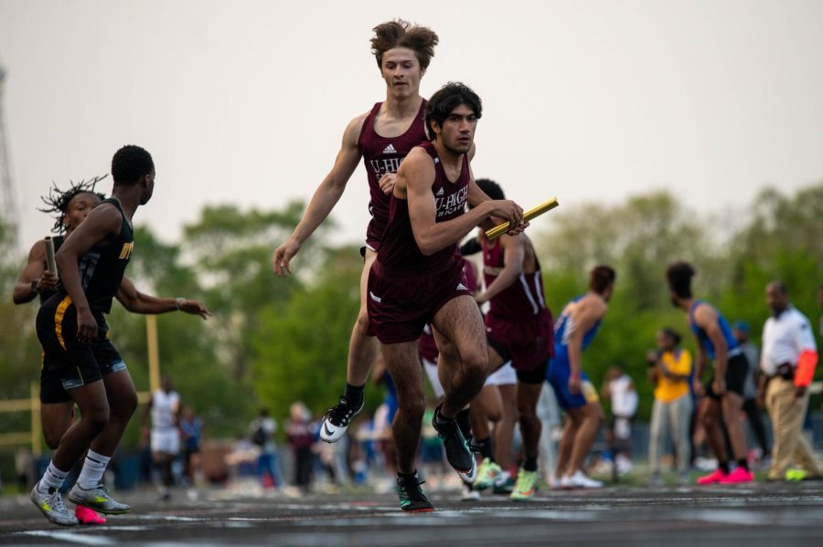 Junior Sam Pastor hands a baton off to sophomore Nyel Khan at the 2A IHSA Sectionals. The boys track team had a strong performance, sending eight students to state. The team did not advance to the state finals. 

